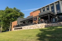 blue sky with green grass and a building with bar none written on it 'Bar None' Brings a Student Vision to Life