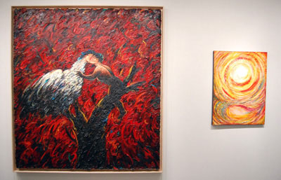 a wall with two art exhibits on display