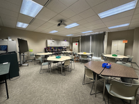 A classroom with the stock market displayed on the wall