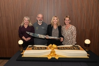 photo of four individuals with a large knife in front of a cake Marywood University Celebrates Grand Opening of Bar None, highlighting vision for vibrant Campus Life