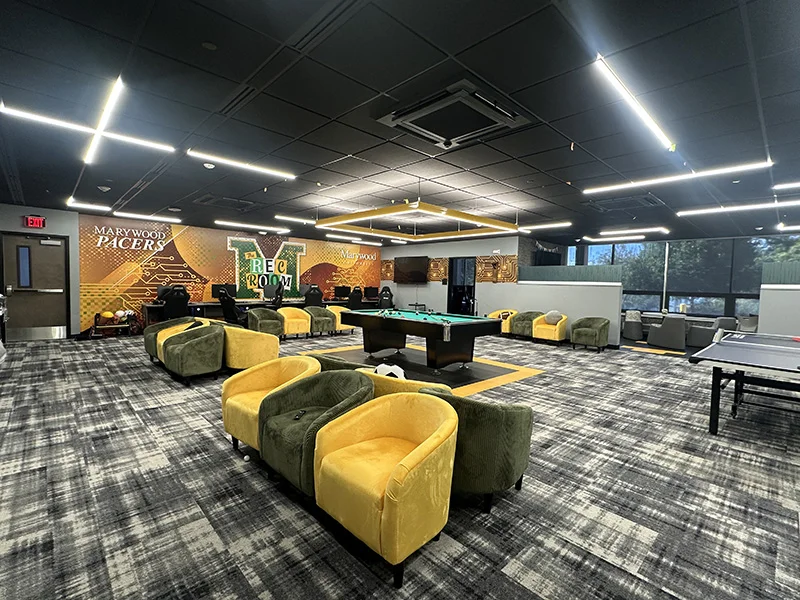 Space with yellow and green chairs and wall and a pool table and tennis table