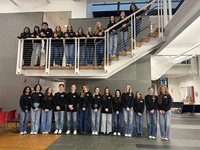 students lined up on staircase and under staircase in blue jeans and black crewnecks Marywood Interior Architecture Students Reimagine Campus Theatre Through National Competition