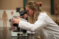 lady looking into a microscope What’s the Difference Between a PA and a Nurse?